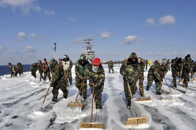 Sailors scrub the flight deck of the U.S.S. Ronald Reagan on March 22, 2011.