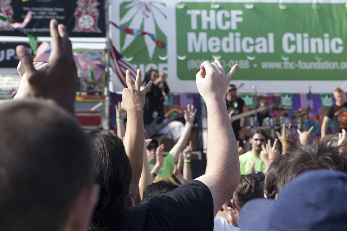 At 4:20 p.m., the crowd put their “O.K” hand signs up before smoking weed together. Photo by Anna Erickson