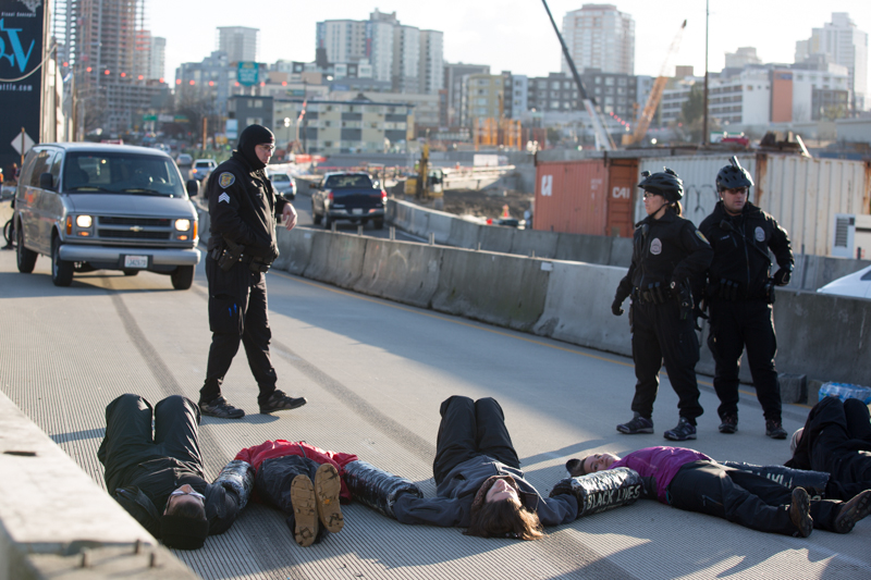 Protesters, locked together with make-shift PVC pipe devices, block traffic on north-bound SR 99.
