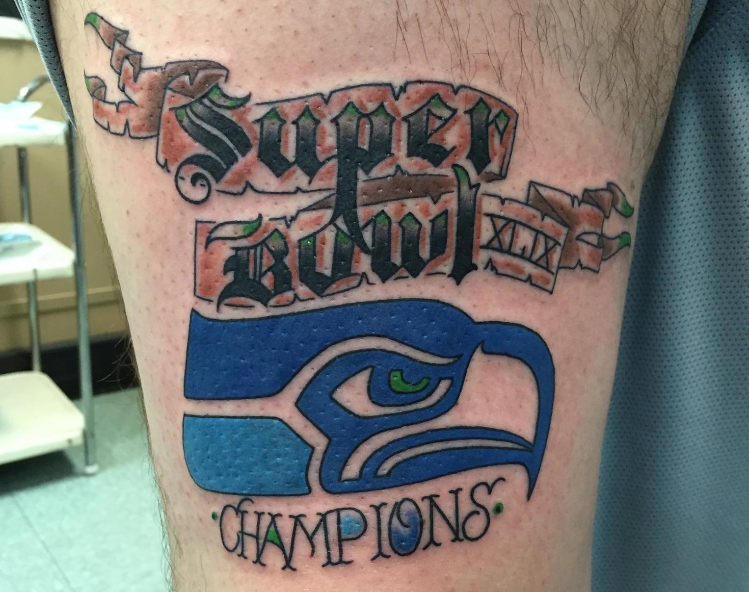 A fan who got a premature "BACK TO BACK CHAMPIONS" tattoo attempts