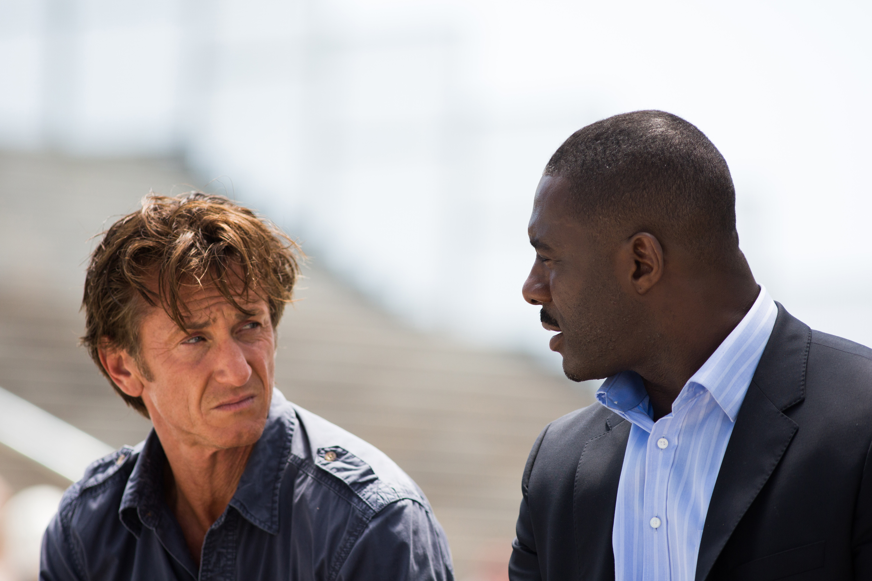 Idris Elba (right) plays an uncertain ally to Penn's woozy gunman.Keith Bernstein/Open Road Films