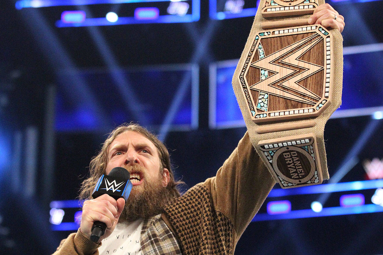 Daniel Bryan flaunts his new eco-friendly WWE Championship. Photo courtesy WWE