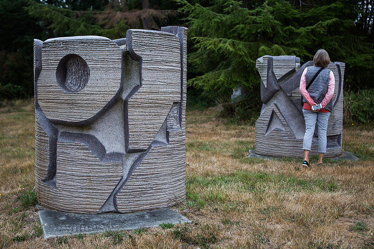 A visitor looks at a sculpture on the Cloudstone outdoor gallery in Freeland. (Olivia Vanni / The Herald)