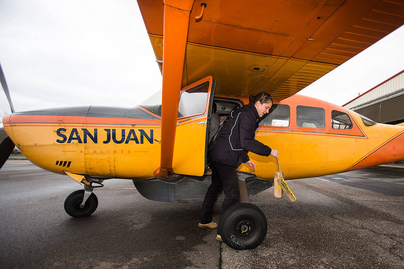 After loading passengers, San Juan Airlines pilot Rebecca Watson pulls chocks before piloting a Cessna 207 for an early morning flight out to the San Juan Islands from Bellingham International Airport on Tuesday, April 23, 2019 in Bellingham, Wash. San Juan Airlines, which has flown small charter flights from Paine Field for decades, will begin twice-daily scheduled flights from Everett to the San Juan Islands on May 1.(Andy Bronson / The Herald)