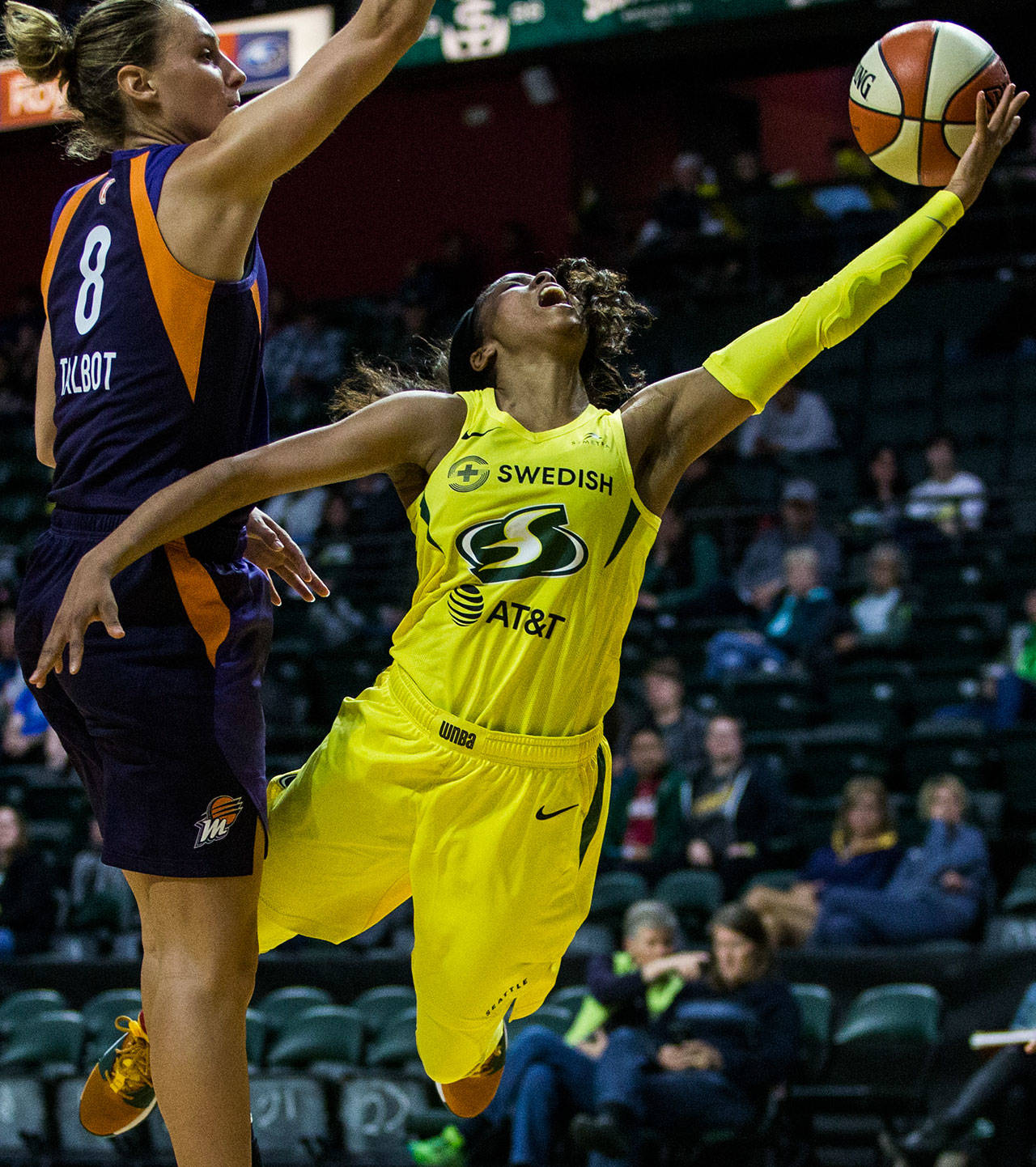 Seattle’s Jordin Canada (right) yells after being fouled by Phoenix’s Stephanie Talbot during a preseason game against Phoenix on Wednesday at Angel of the Winds Arena in Everett. (Olivia Vanni / The Herald)