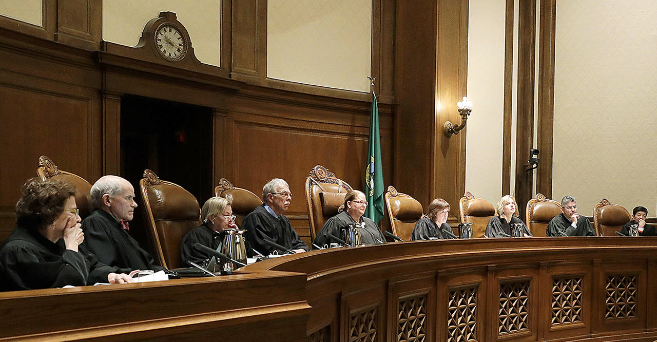 Justices on the Washington Supreme Court listen to testimony during a Jan. 22 hearing in Olympia, on a lawsuit addressing the constitutional freedom of state presidential electors to vote for any candidate for president, not just the nominee of their party. (AP Photo/Ted S. Warren, file)