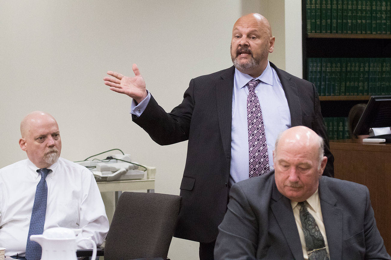 William Talbott II, left, listens as his public defender Jon Scott questions potential jurors at the Snohomish County Courthouse on Thursday, June 13, 2019 in Everett, Wash. Snohomish County sheriff’s detective Jim Scharf, right, listens from the prosecutor’s table. (Andy Bronson / The Herald)