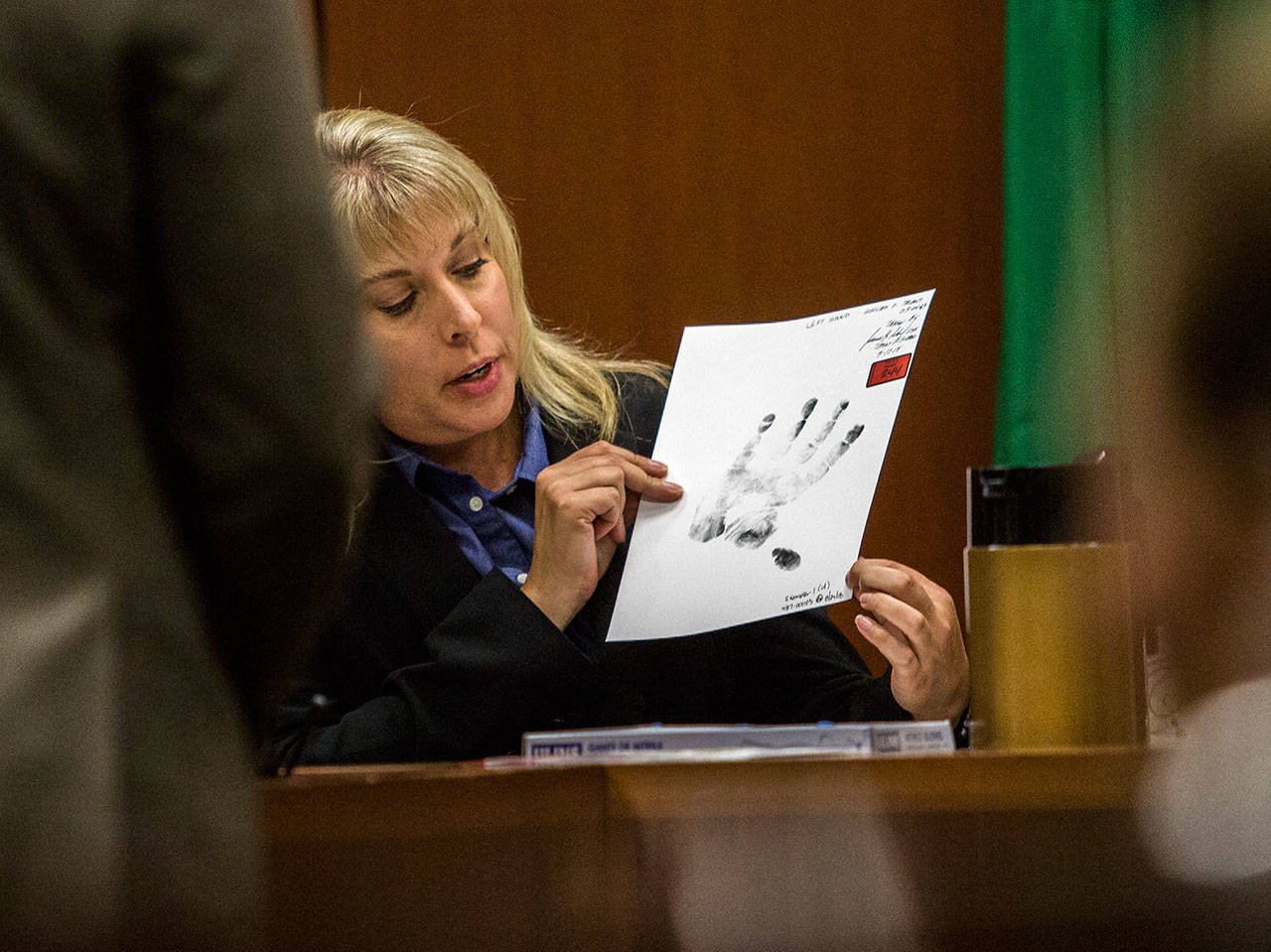Washington State Patrol forensic scientist Angela Hilliard shows and talks about a palm print of William Talbot II during the trial at the Snohomish County Courthouse on Tuesday in Everett. (Olivia Vanni / The Herald)