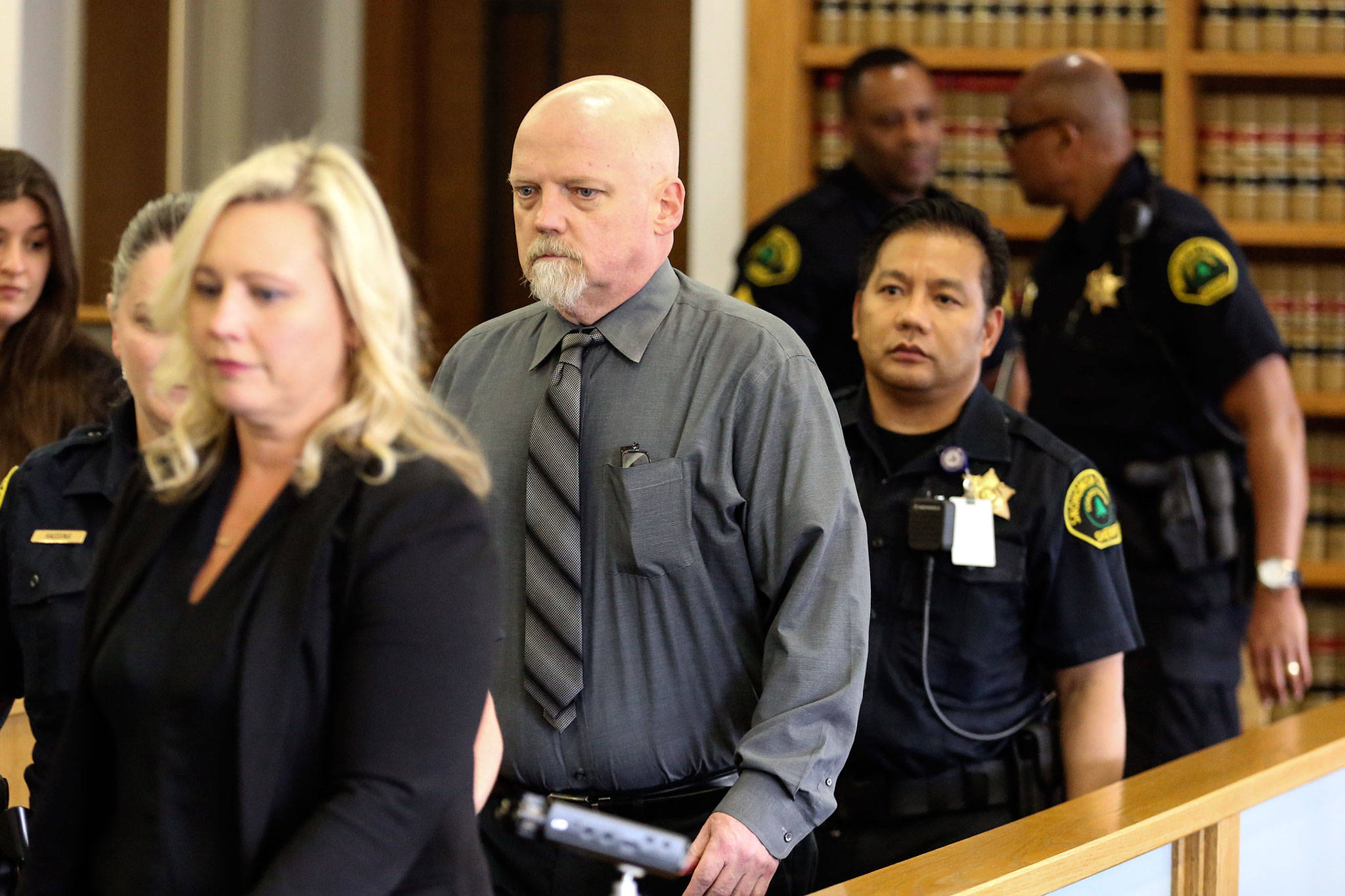 William Talbott II (center) in escorted to his seat Friday morning at the Snohomish County Court House in Everett. Talbott was found guilty of the murder of Jay Cook and Tanya Van Cuylenborg. (Kevin Clark / The Herald)
