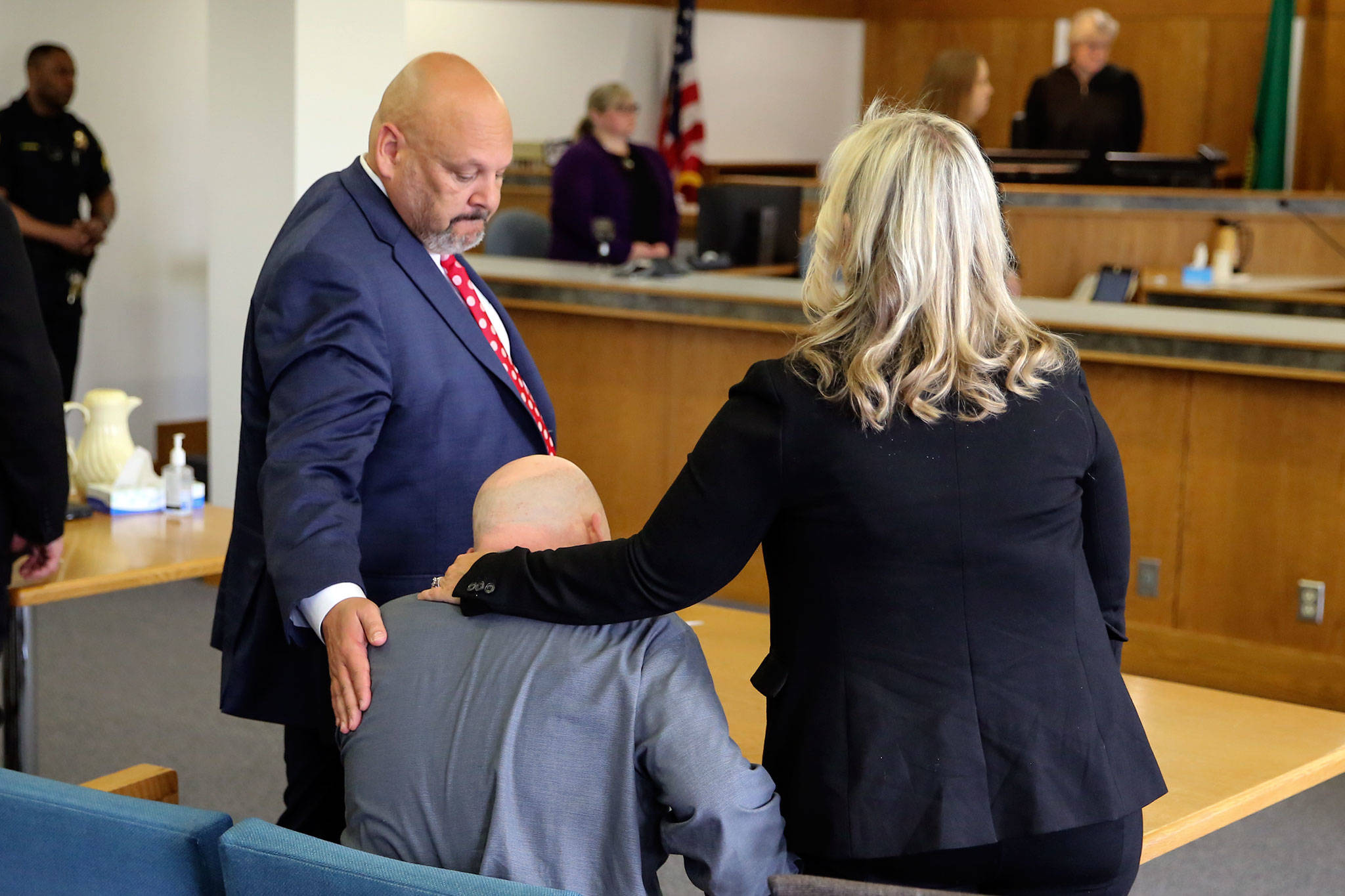 Defense attorneys Jon Scott (left) and Rachel Forde (right) stand as the jury is dismissed with William Talbott II seated Friday morning at the Snohomish County Court House in Everett on June 28, 2019. Talbott was found guilty of all charges. (Kevin Clark / The Herald)