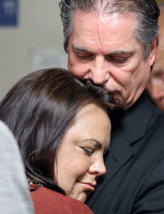 Laura Baanstra, sister of Jay Cook, and her husband, Gary Baanstra, hug during the press conference after the trial of William Talbott II Friday morning at the Snohomish County Court House in Everett. Talbott was found guilty of all charges. (Kevin Clark / The Herald)