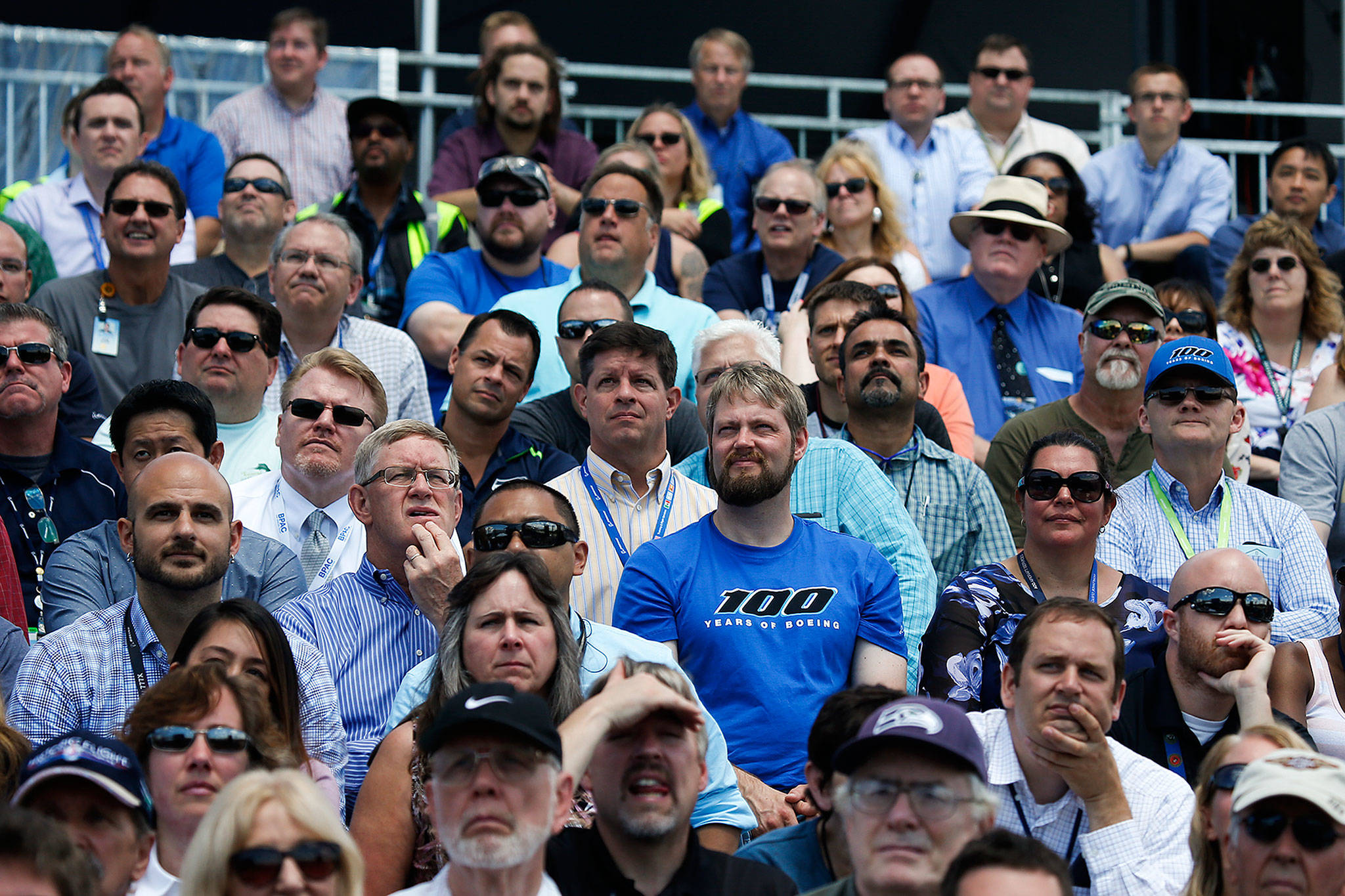Wearing a Boeing 100th anniversary T-shirt, Everett employee Matt Carlsen stands among other workers and retirees at a centennial celebration at Boeing Field in Seattle in 2016. (Ian Terry / Herald file)