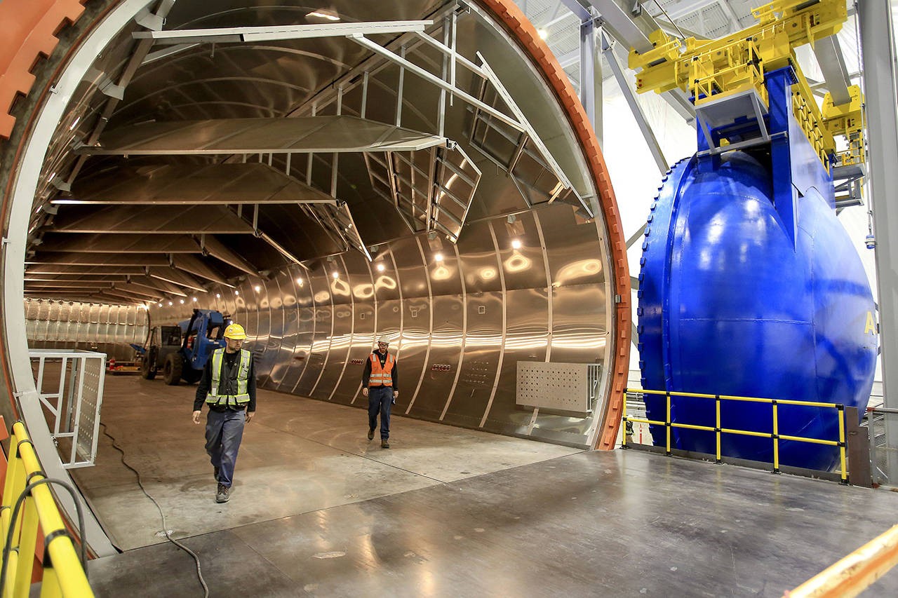 Crews walk the autoclave at the new 777x Composite Wing Center at Paine Field in Everett on May 19, 2016. (Kevin Clark / Herald file)