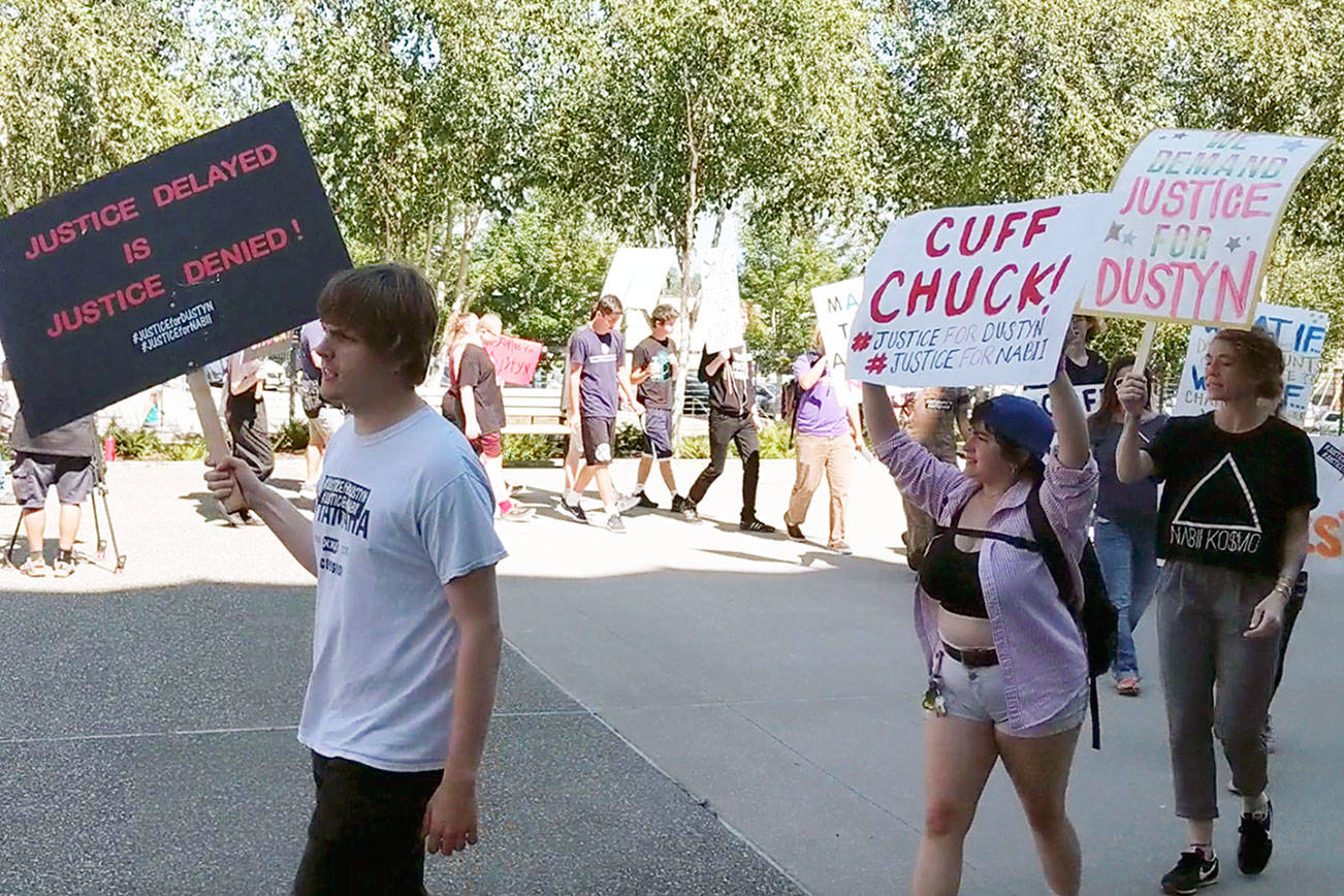 Friends and family of Dustyn Hunt-Bagby marched and chanted in front of the Snohomish County Courthouse on Monday to call attention to the apparent lack of progress in the investigation into his death. (Zachariah Bryan / The Herald)