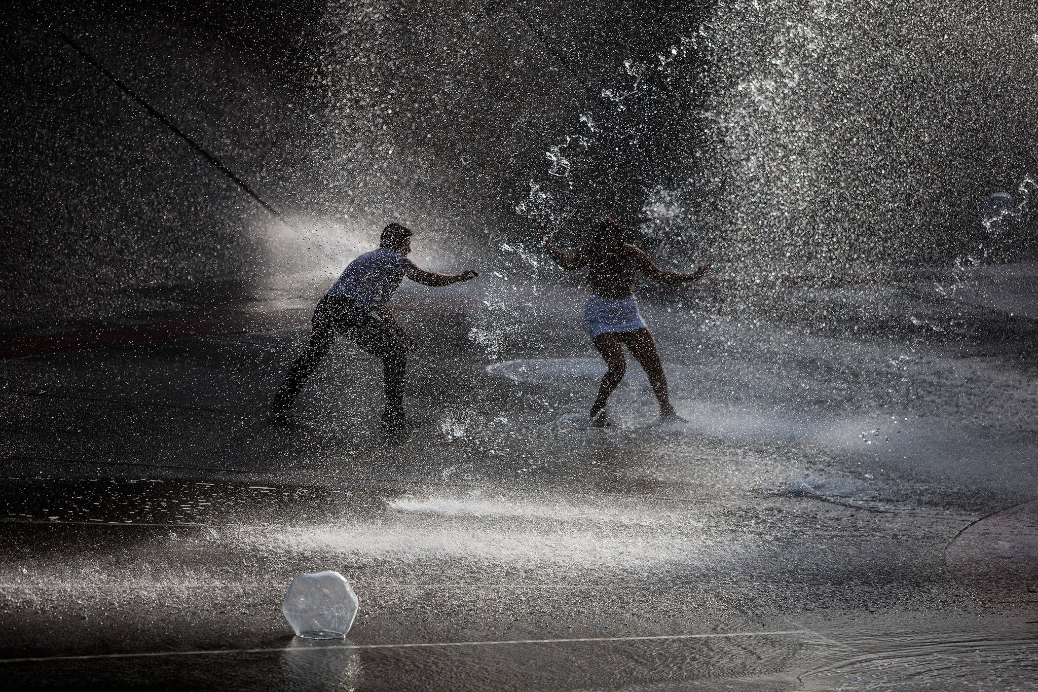 People play in the Seattle Center fountain during Bumbershoot Music & Arts Festival on Friday, Aug. 30, 2019 in Seattle, Wash. (Olivia Vanni / The Herald)