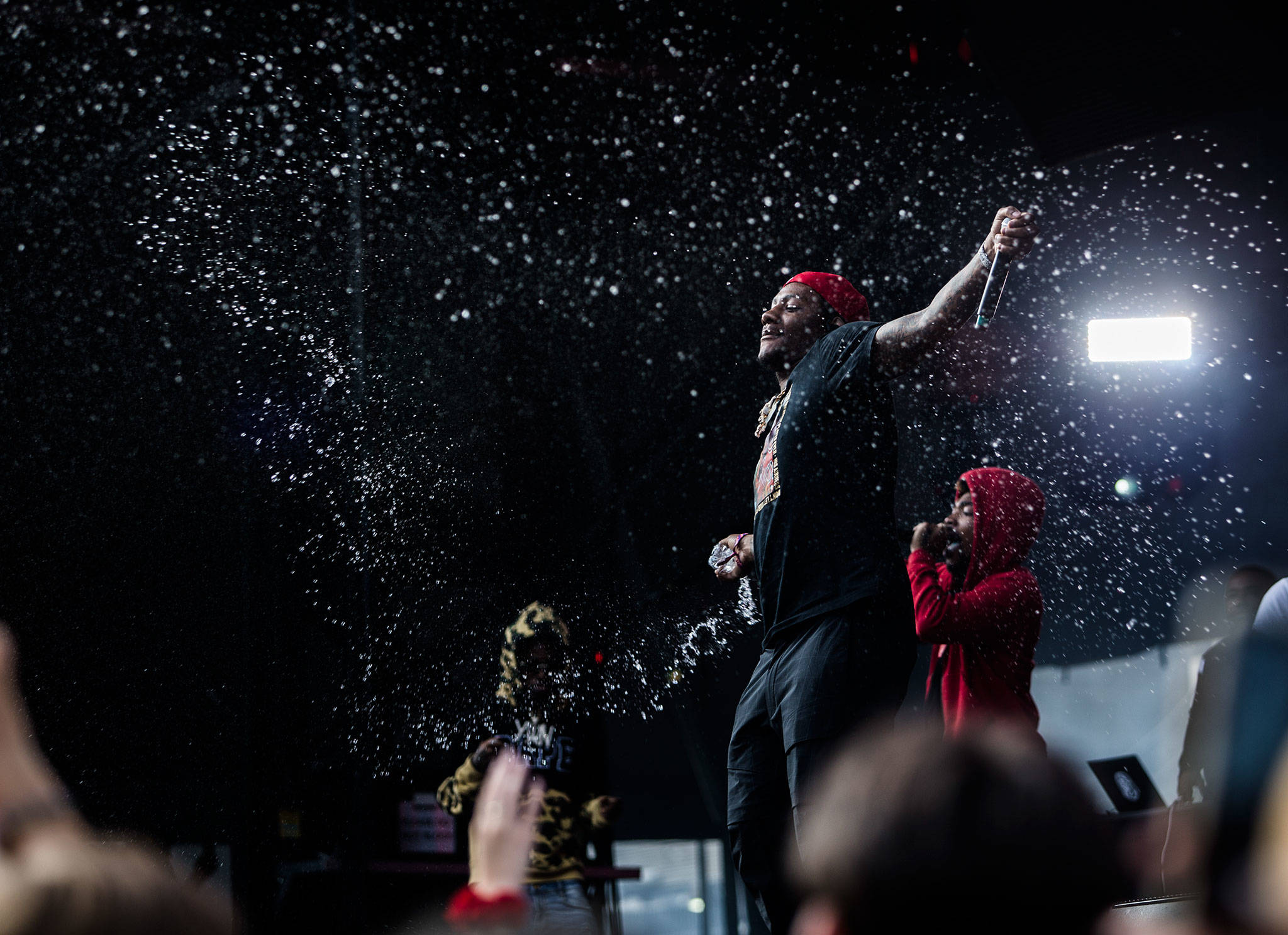 SOBxRBE sprays the crowd with water during their performance at Bumbershoot Music & Arts Festival on Friday, Aug. 30, 2019 in Seattle, Wash. (Olivia Vanni / The Herald)