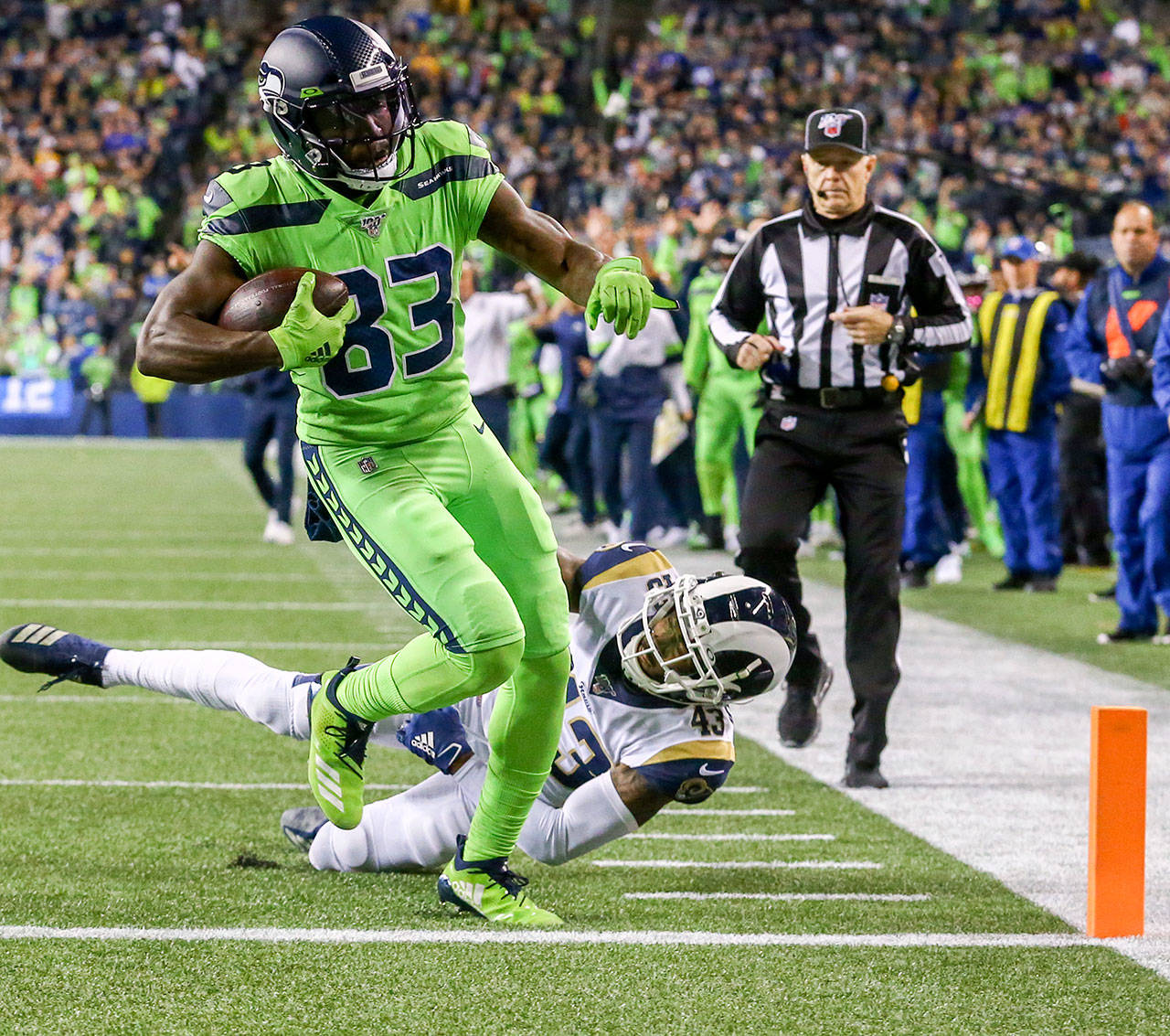 Seattle’s David Moore (83) scores on a 10-yard touchdown pass as the L.A. Rams John Johnson dives to stop him in the third quarter of the Seahawks 30-29 win Thursday at CenturyLink Field in Seattle. (Kevin Clark / The Herald)