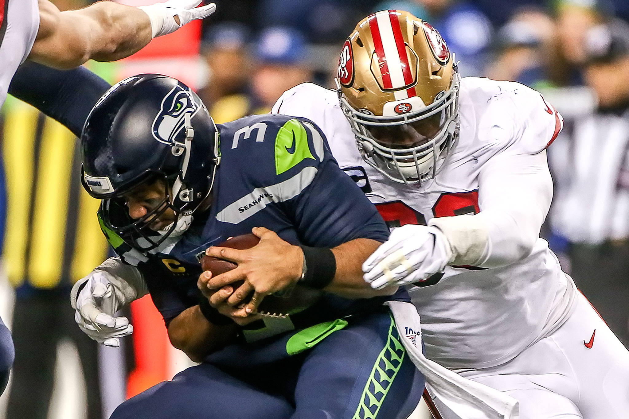 San Francisco’s DeForest Buckner sacks Seattle Seahawks’ Russell Wilson in the second quarter Sunday evening at CenturyLink Field in Seattle on December 29, 2019. The 49ers led 13-0 at the half. (Kevin Clark / The Herald)