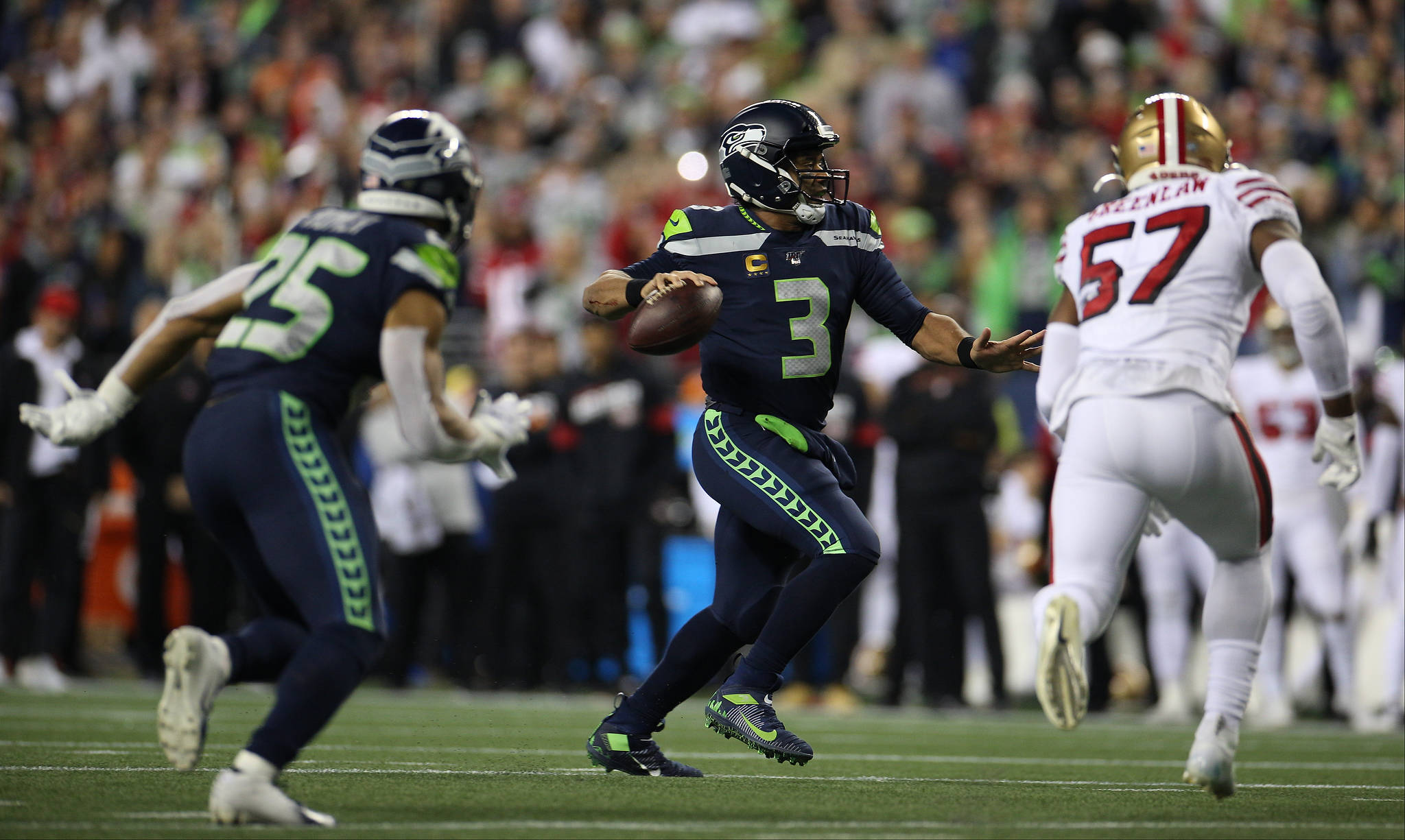 Seattle Seahawks’ Russell Wilson runs forward to throw a touchdown pass as the Seattle Seahawks lost to the San Francisco 49ers 26-21 at CenturyLink Field on Sunday, Dec. 29, 2019 in Seattle, Wash. (Andy Bronson / The Herald)