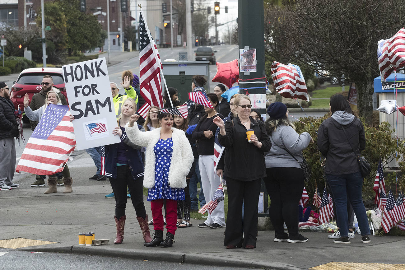Honks, waves, flags and flowers for Everett’s tattooed patriot