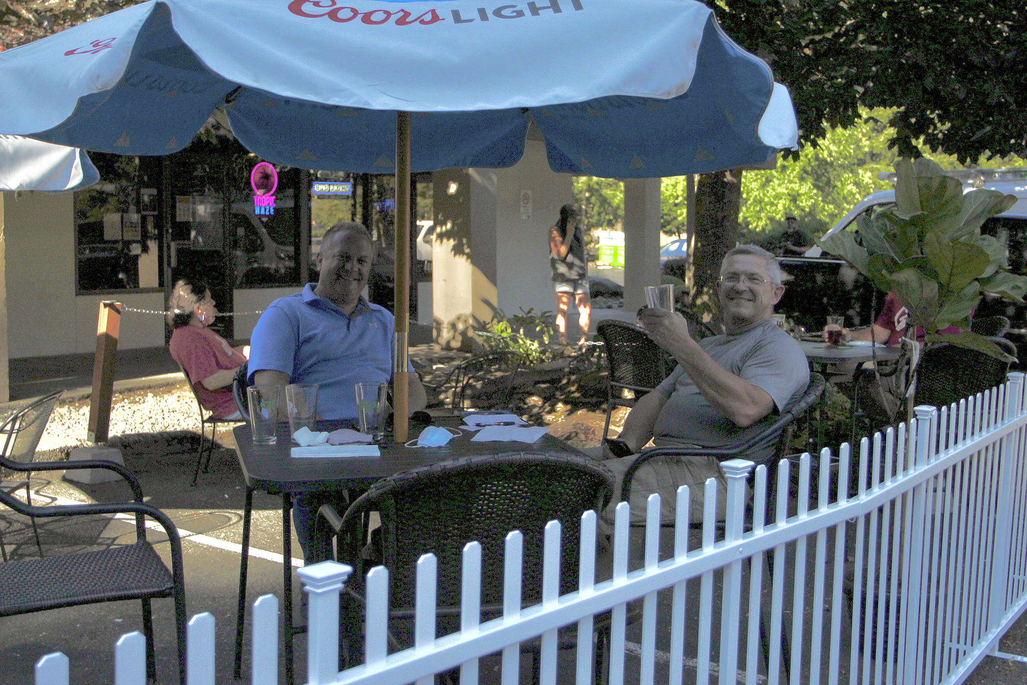 Federal Way residents Kevin Jochim, left, and Steve Reichel enjoy drinks on the new patio area at JP’s Tavern on Aug. 5. File photo