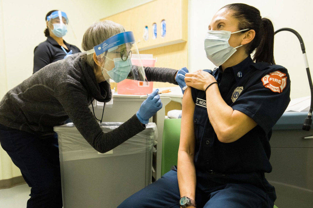 Public Health – Seattle & King County staff administering COVID-19 vaccine to a local emergency responder. COURTESY FILE PHOTO, Public Health-Seattle & King County