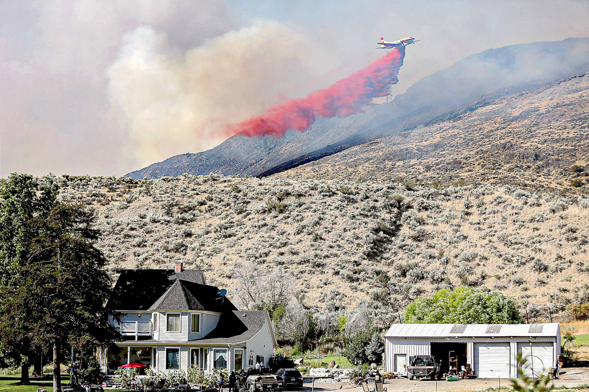 A plane drops fire retardant on the Palmer Mountain Fire last summer in north-central Washington. Laura Knowlton/Sound Publishing staff photo