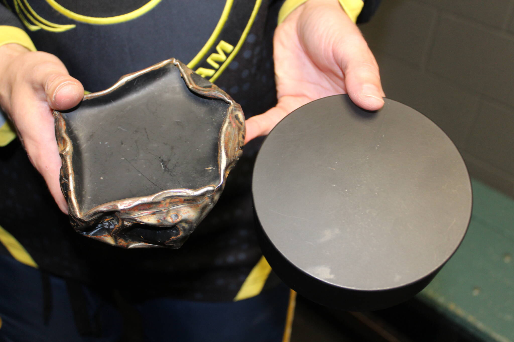 The difference between a blind hockey puck used after one game and a brand new one. Photo by Bailey Jo Josie/Sound Publishing