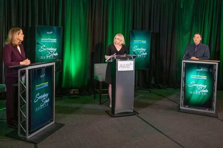 Pierce County Auditor Julie Anderson, left, debates Secretary of State Steve Hobbs on Aug. 17 with moderator Melissa Santos of Axios Local in the center. (Photo by Brian Mittge/Association of Washington Business)