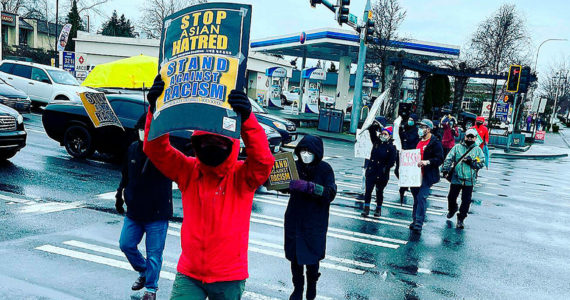 Supporters hold signs at a “Stop Asian Hate” rally in Federal Way in March 2021. File photo