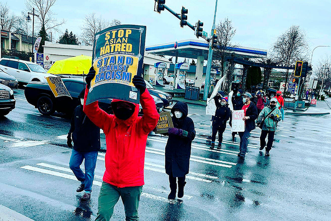 Supporters hold signs at a “Stop Asian Hate” rally in Federal Way in March 2021. File photo