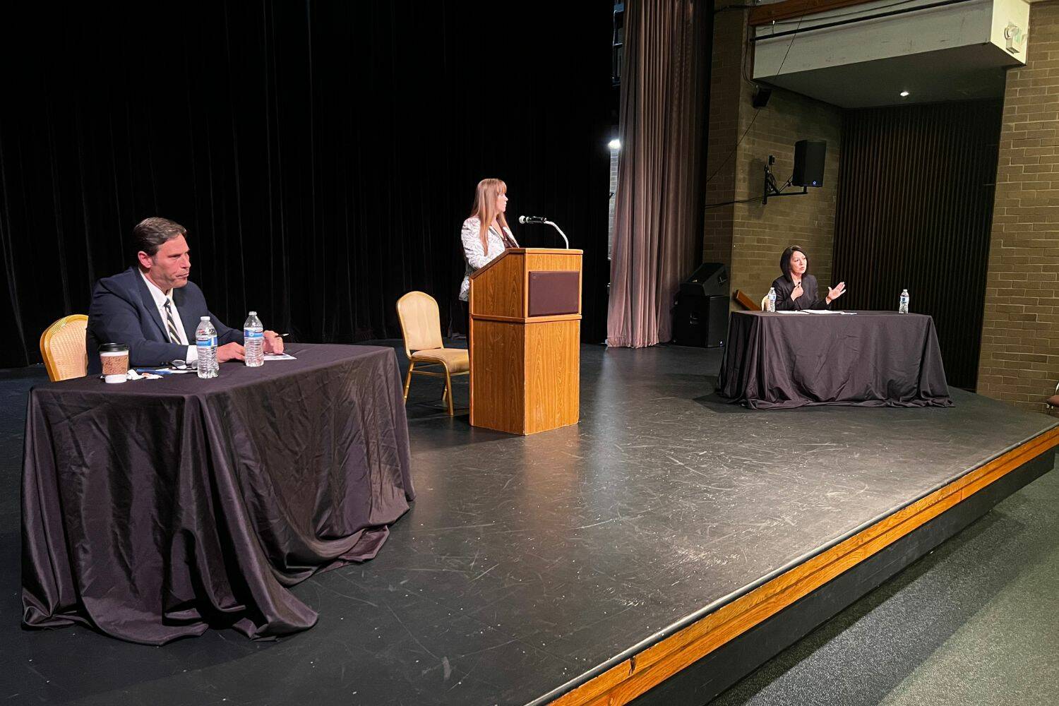 King County prosecutor candidates Jim Ferrell (left) and Leesa Manion debate Sept. 28 at Carco Theatre in Renton. The forum was moderated by Renton Chamber of Commerce CEO Diane Dobson (center). Photo by Cameron Sheppard/Sound Publishing