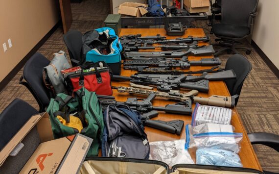 Law enforcement seized approximately 19 firearms, 3,372 grams of suspected methamphetamine, 1,322 grams of suspected fentanyl-laced pills, and over $210,000 in United States currency. (Courtesy of the Department of Justice)