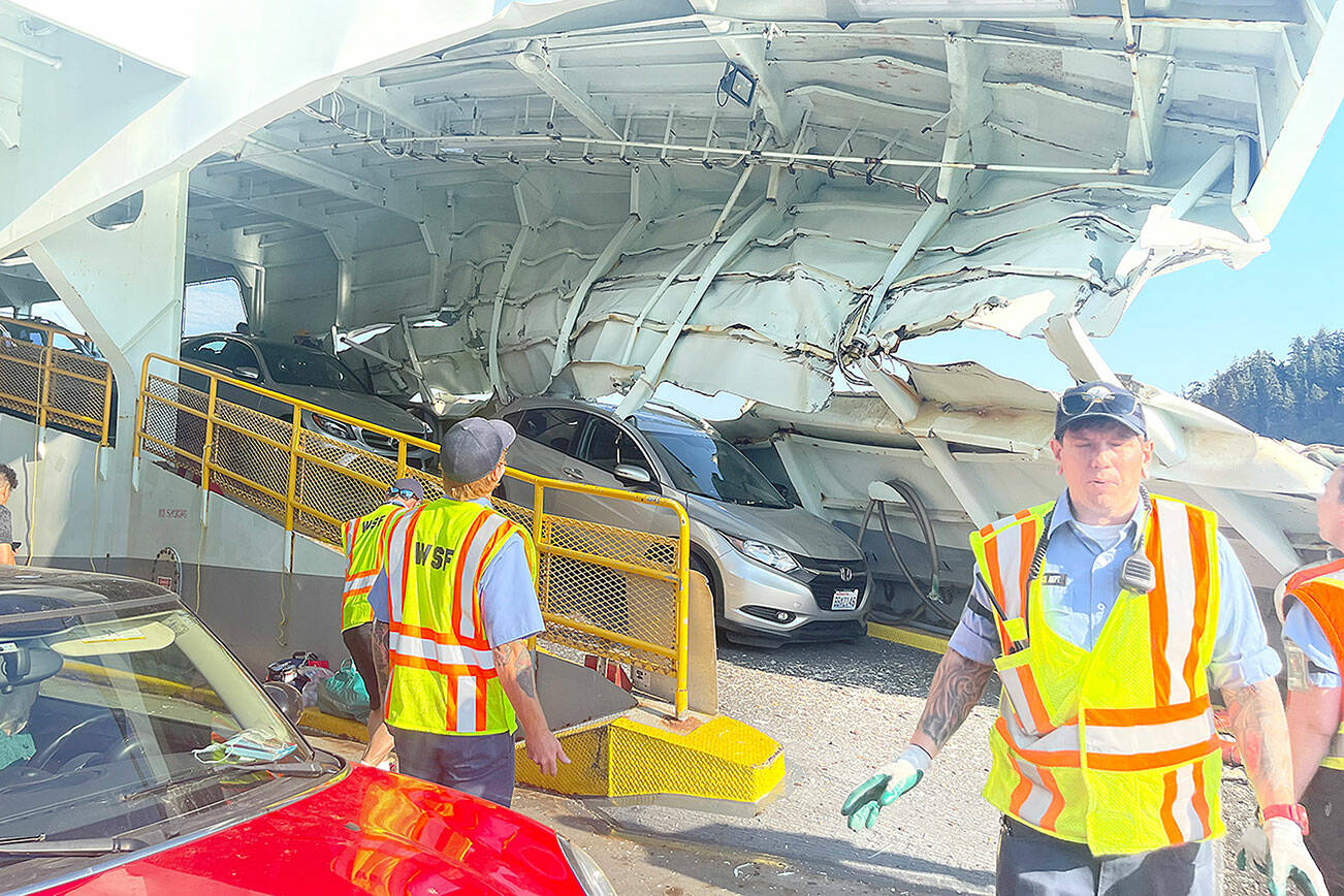 In the immediate aftermath of the crash of the Cathlamet in July 2022, ferry workers and passengers surveyed the serious damage to the boat, which pinned one car in folded steel. (Photo courtesy of Pam Kirkpatrick)