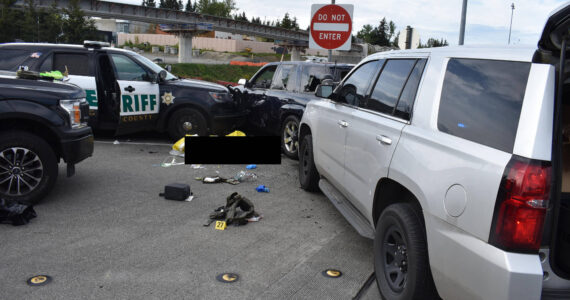 Cicero Sanchez, 31, lays dead at the scene near South 317th Street and 28 Avenue South after two King County Sheriff’s Office deputies shot him following a vehicle pursuit on May 4, 2022. Multiple vehicles, both unmarked and marked, surround Sanchez’s vehicle. A King County Sheriff’s Office vehicle pins the driver’s door of Sanchez’s vehicle shut with the window half open. The original family liaison for the Sanchez family, Douglas Faini, said in an email that Sanchez climbed out of the open window. Sanchez’s body has been censored with a black box by this newspaper’s editorial staff. (Photo courtesy of Cristy Sanchez)