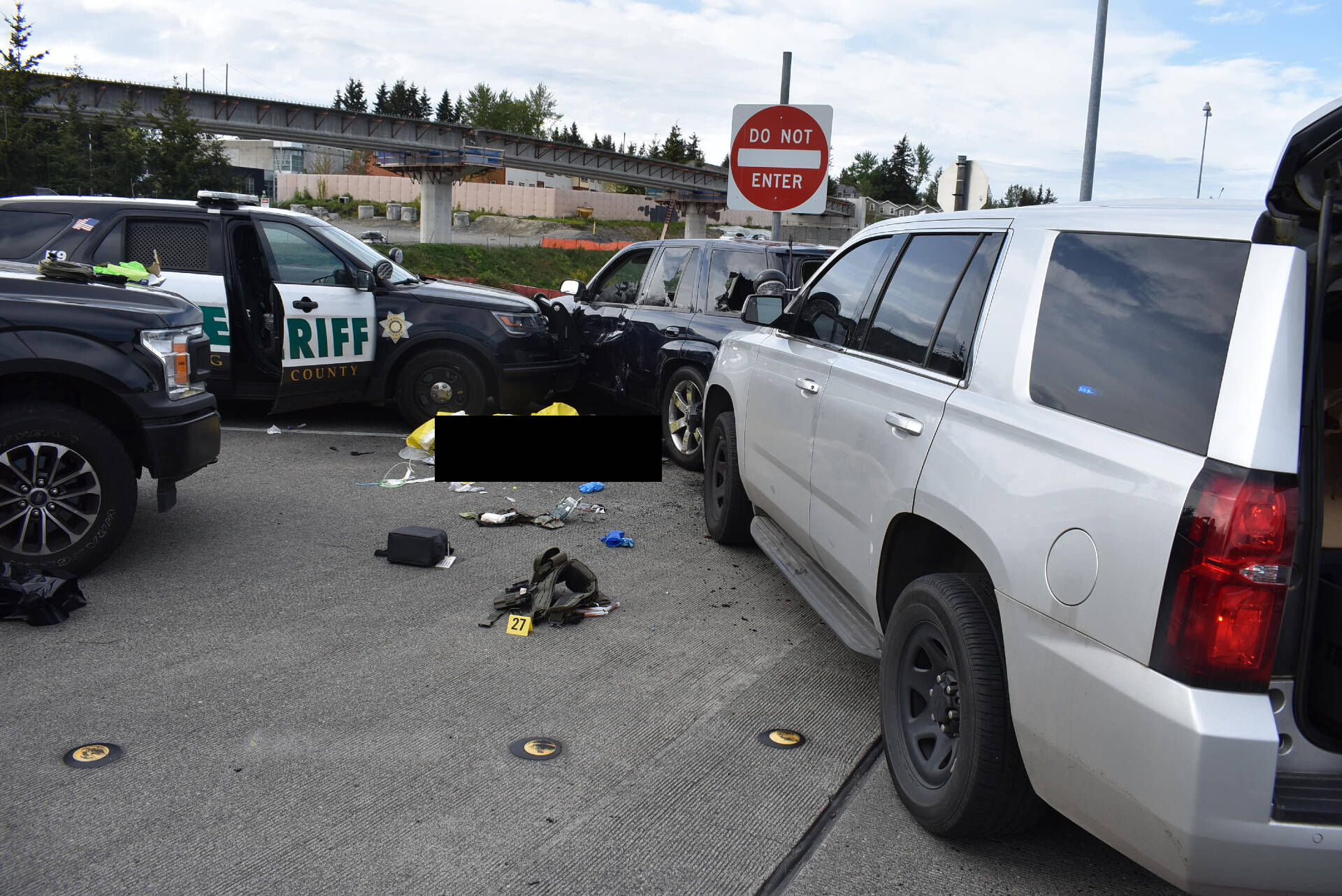 Cicero Sanchez, 31, lays dead at the scene near South 317th Street and 28 Avenue South after two King County Sheriff’s Office deputies shot him following a vehicle pursuit on May 4, 2022. Multiple vehicles, both unmarked and marked, surround Sanchez’s vehicle. A King County Sheriff’s Office vehicle pins the driver’s door of Sanchez’s vehicle shut with the window half open. The original family liaison for the Sanchez family, Douglas Faini, said in an email that Sanchez climbed out of the open window. Sanchez’s body has been censored with a black box by this newspaper’s editorial staff. (Photo courtesy of Cristy Sanchez)