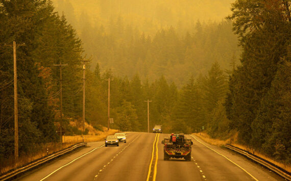 An emergency fire vehicle heads past a barricade and towards Index as numerous agencies attempt to contain the Bolt Creek Fire on Saturday, Sep. 10, 2022, on U.S. Highway 2 near Index, Washington. (Ryan Berry / The Herald)