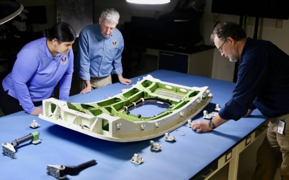 NTSB investigators examine the MED plug from Alaska Airlines flight 1282. (Photo courtesy of National Transportation Safety Board)