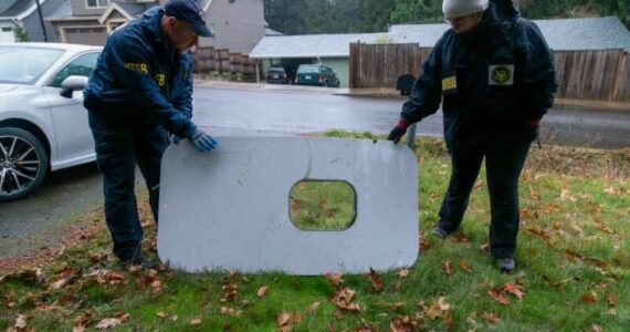 The plane door that flew off of the Alaska Airlines flight 1282 Boeing 737-9 MAX found by NTSB investigators in a Portland resident’s backyard. (Courtesy of NTSB)