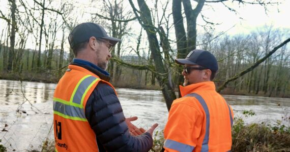King County Flood Patrol members Thomas Bannister (left) and Seth Ballhorn on their patrol route, Dec. 9, 2025. (Grace Gorenflo/Sound Publishing)