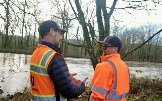 King County Flood Patrol members Thomas Bannister (left) and Seth Ballhorn on their patrol route, Dec. 9, 2025. (Grace Gorenflo/Sound Publishing)