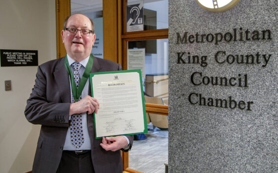 Dwight Dively poses with the proclamation and the MLK Medal of Distinguished Service. Photo courtesy of King County