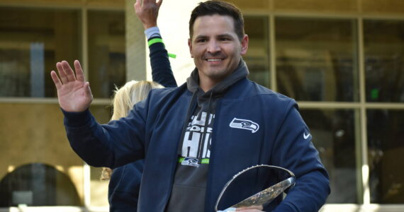 Seahawks head coach Mike Macdonald waves and holds the Lombardi Trophy during the parade. Photos by Ben Ray / Sound Publishing