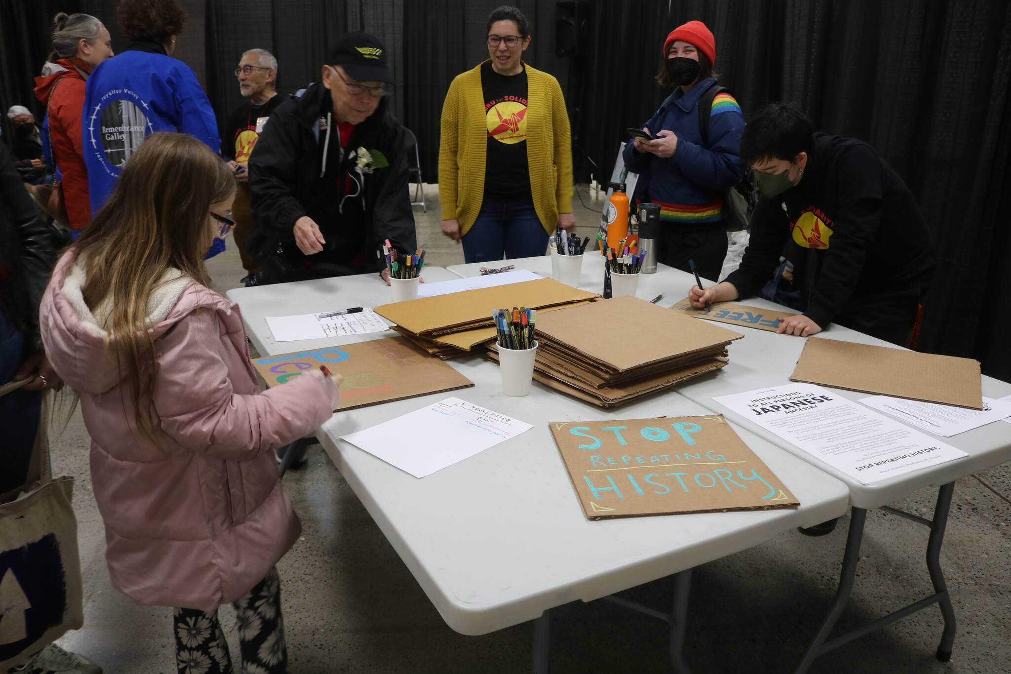 Participants make signs to bring to the Solidarity Day demonstration at the Northwest Detention Center in an event organized by Tsuru for Solidarity and La Resistencia. Photo by Bailey Jo Josie/Sound Publishing