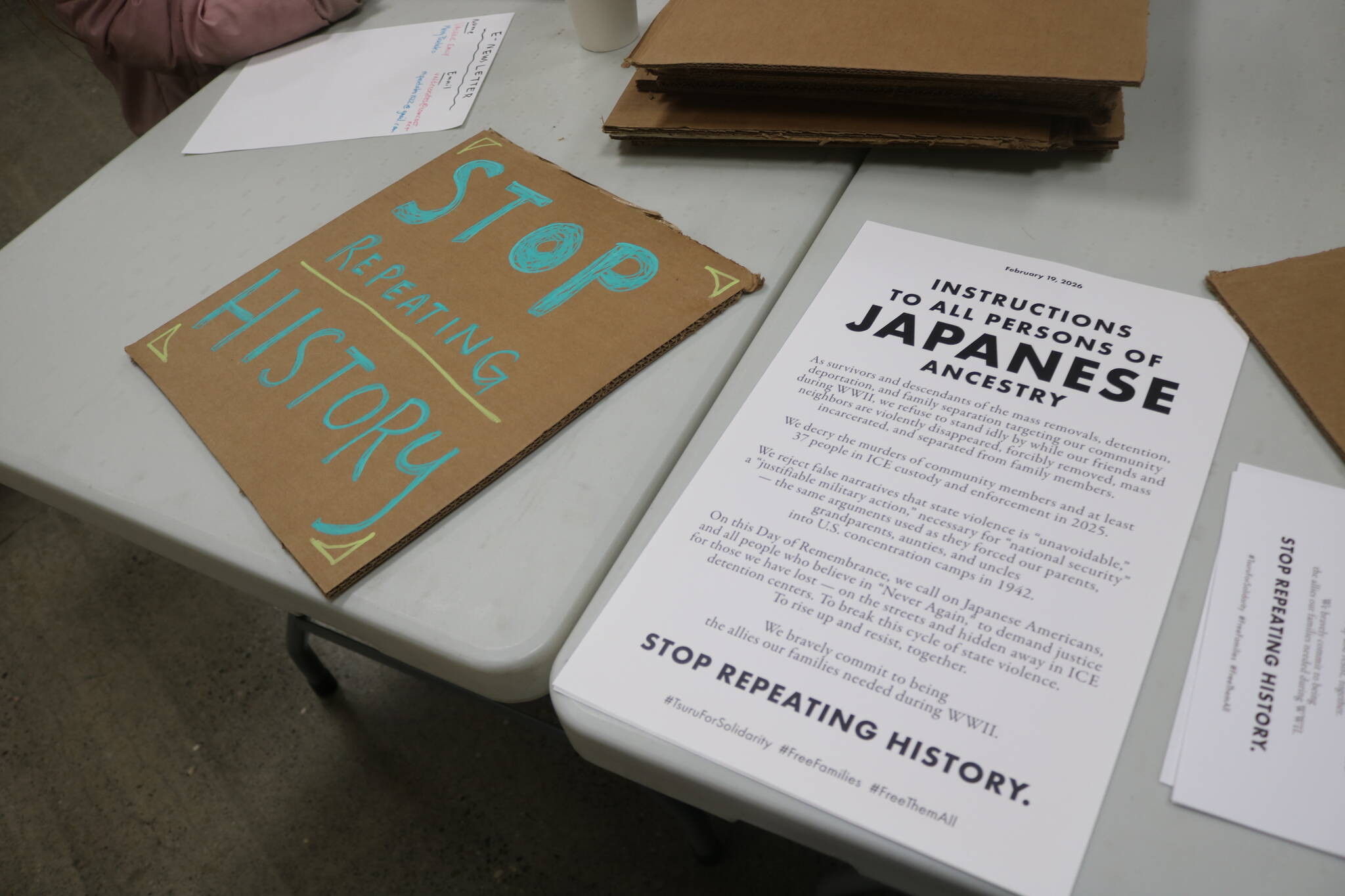 A sign created by a community member rests next to an updated version of Executive Order 9066 from Tsuru for Solidarity, this time calling for descendants and survivors to stand up against state violence against immigratn communities. Photo by Bailey Jo Josie/Sound Publishing