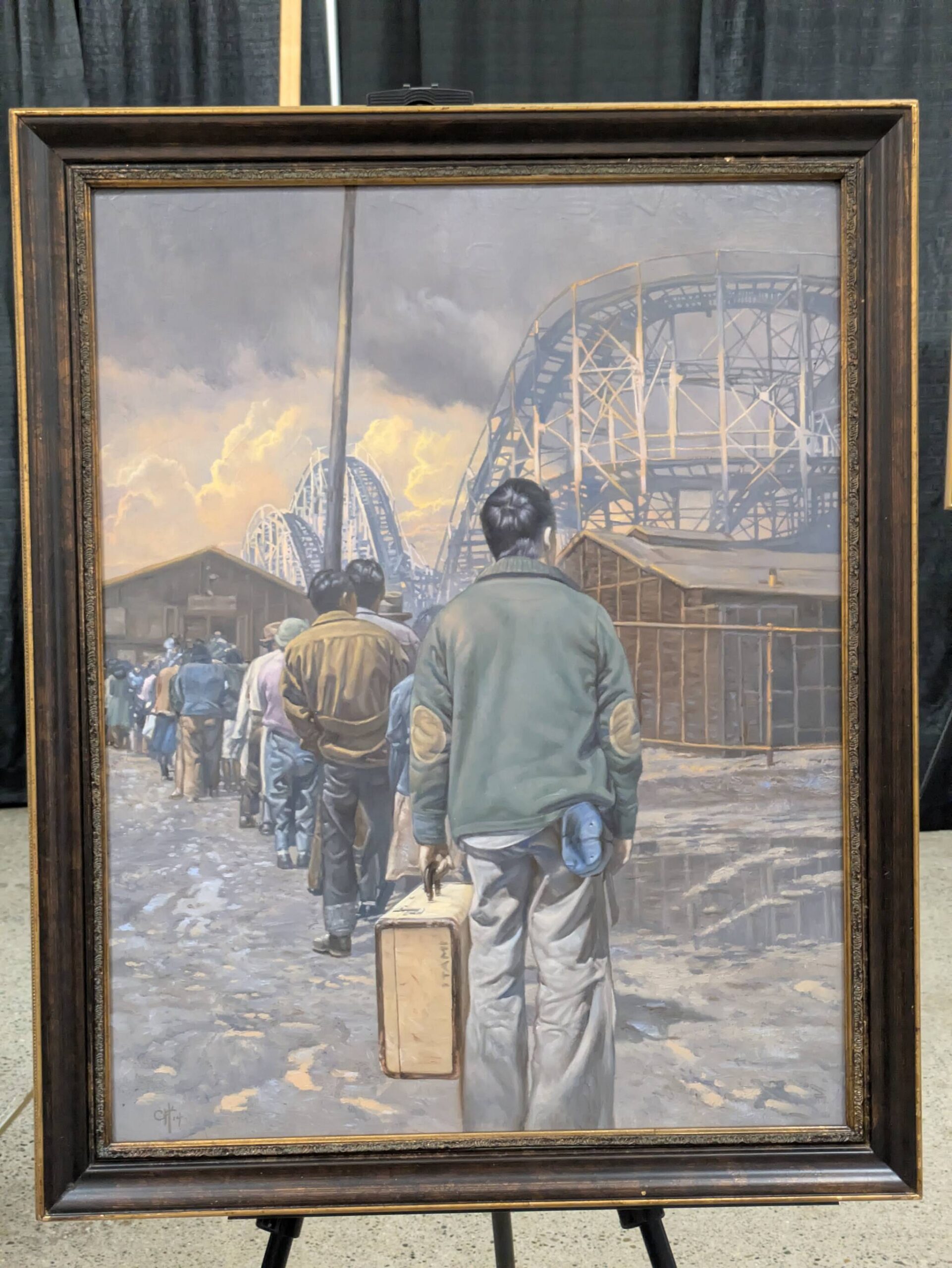 Photo by Bailey Jo Josie/Sound Publishing
A painting by Chris Hopkins explores the incarceration experience, this one highlighting the stark contrast of the use of the Washington State Fairgrounds for imprisoning Japanese American families with its other uses for entertainment as a rollercoaster looms above those entering the Puyallup Assembly Center.