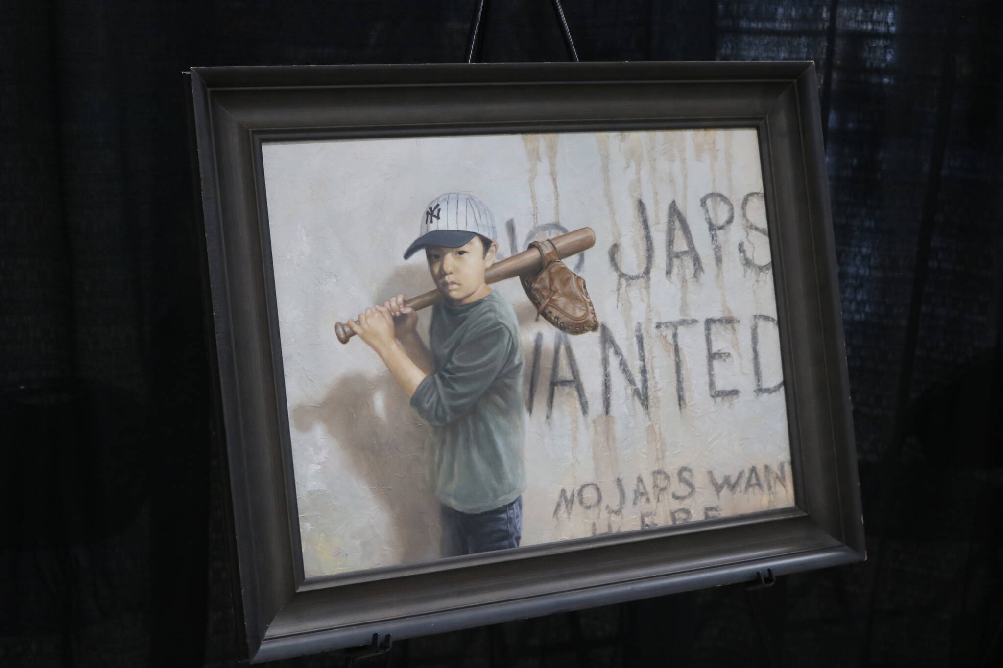 A painting by Chris Hopkins depicts incarceration from a childs perspective, balancing recreation and the experience of racism during WWII. Photo by Bailey Jo Josie/Sound Publishing