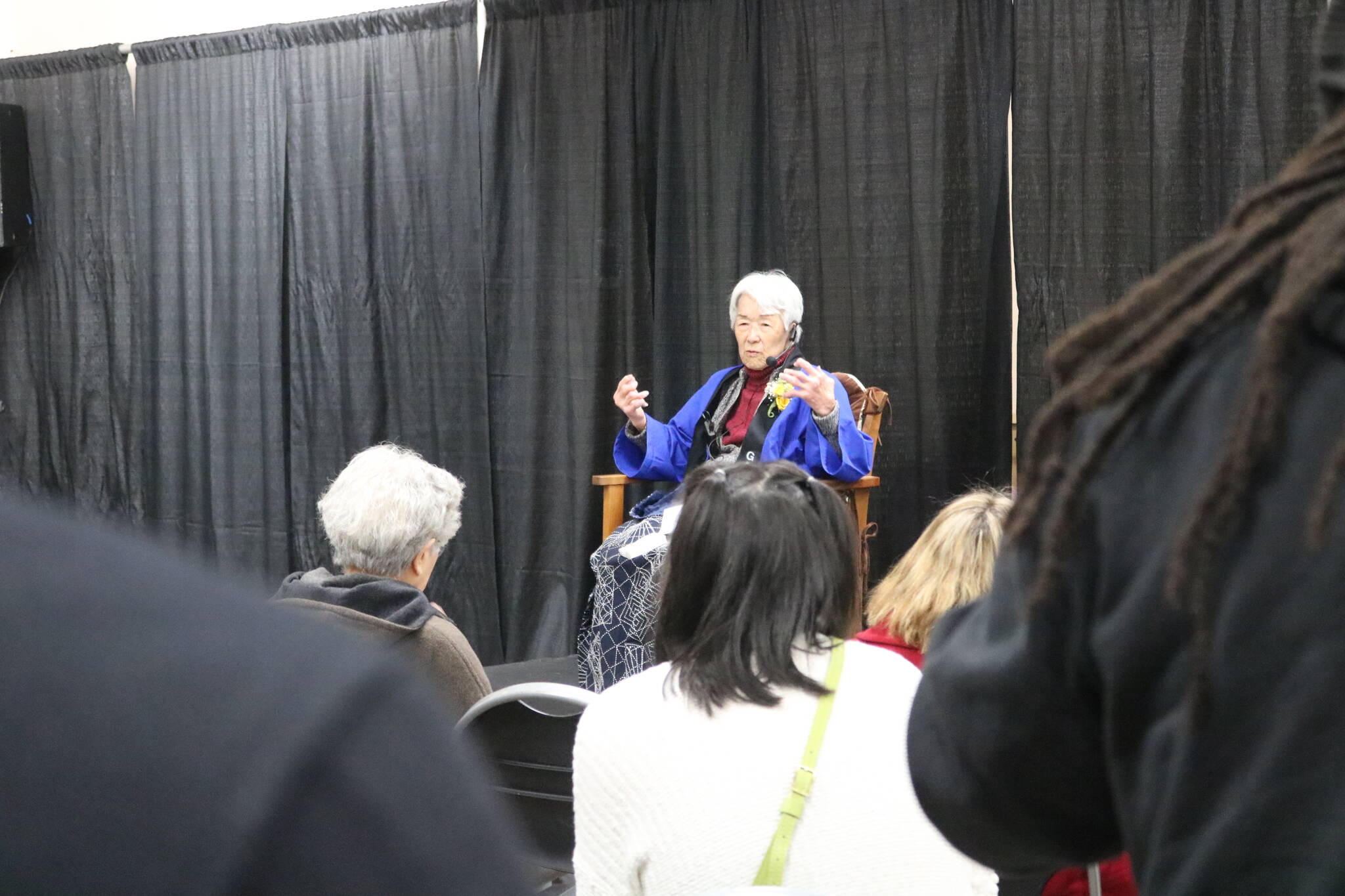 Audience members listen to survivor Hana Konishi tell the story of being incarcerated as a child with her family. Photo by Bailey Jo Josie/Sound Publishing