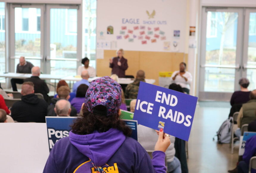<p>An attendee at the Feb. 21 town hall in Federal Way holds a sign calling for an end to ICE raids. Courtesy photo</p>