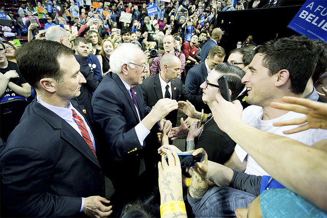 Democratic presidential candidate Senator Bernie Sanders shakes hands with supporters at KeyArena following his rally on March 20, 2016 in Seattle.
